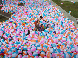 biker wading through inflatable balls